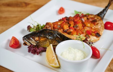 Grilled fish stuffed with different vegetablesの写真素材