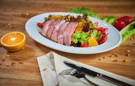 Plate with mouthwatering gourmet dish with roasted duck breast and salad with vegetableの写真素材