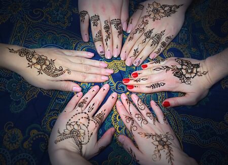 Circle of female hands decorated with mehendi. Woman's hands with mehendiの写真素材