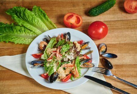 Healthy salad with shrimp, mussels, tomatoes and lettuce leaf, close-upの写真素材