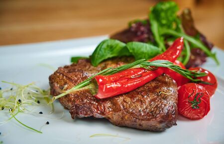 Juicy steak. Dish of meat on a plate adding with shrimps, tomatoes and saladの写真素材