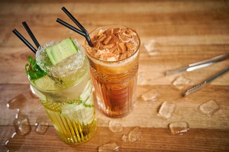 Two glasses with refreshing drinks. Delicious refreshing waters with cucumber and cinnamon in glassesの写真素材
