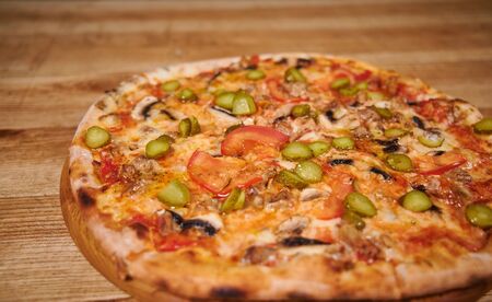 Italian pizza. Delicious fresh pizza served on wooden tableの写真素材