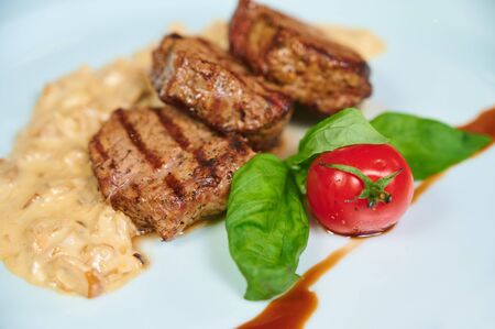 Close-up of beef steaks with tomato and sauce. Top viewの写真素材