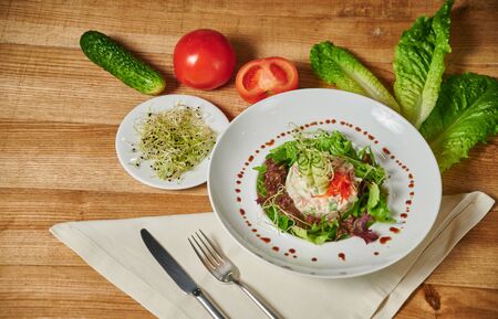 Healthy salad with vegetable, close-up. Cucumbers, tomatoes and lettuce leafの写真素材