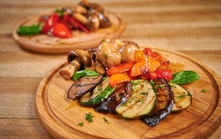 Grilled vegetables mix on wooden plateの写真素材