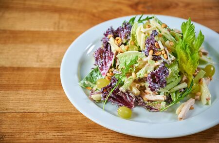 Waldorf Salad with apples, celery and pine nuts on a plateの写真素材