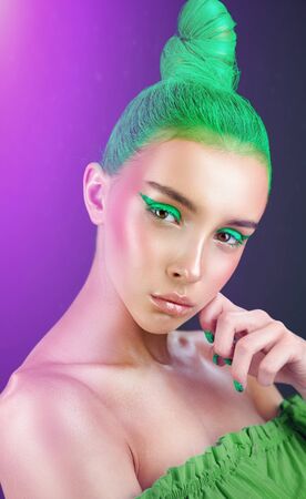 High fashion model. Amazing woman with green hairstyle and arrows on her eyesの写真素材