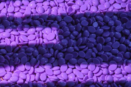 Abstract beautiful backdrop. Wallpaper. Granules for hair removal. Purple wax granulesの写真素材