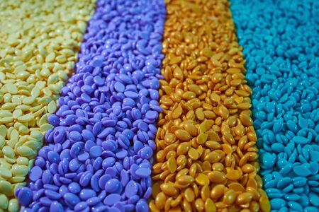 Granules for depilation. Abstract beautiful backdrop. Wallpaper. Granules for hair removal. Colorful wax granulesの写真素材