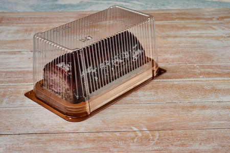 swiss chocolate roll, roll, cream roll, swiss log. Sold in a supermarket. Plastic box. Biscuit, jam and cream.の写真素材