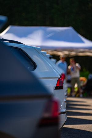 Cars parked in a row in front of a tent at a car showの写真素材