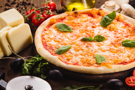 Classic Italian Pizza "Margarita" on a dark wooden background (close)の写真素材