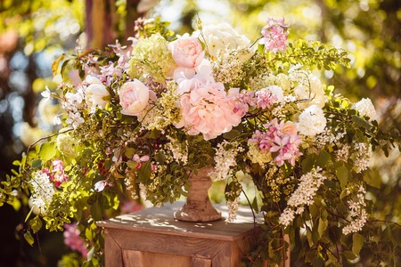Wedding decoration ceremony. Fresh flowers in vasesの写真素材