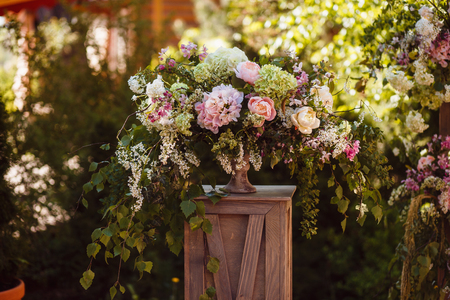 Wedding decoration ceremony. Fresh flowers in vasesの写真素材