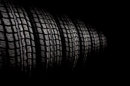 new winter tires in a row. Black and white photo with vignetteの写真素材