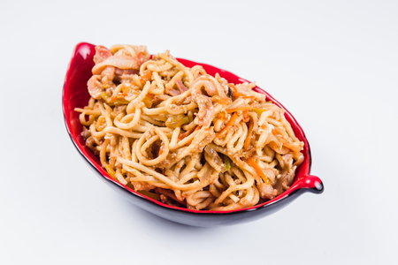 noodles with bacon and pepper on a red plate on a white background. Traditional Italian pasta. Closeの写真素材