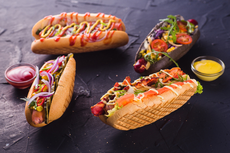 Four hot dog on a dark background (close)の写真素材