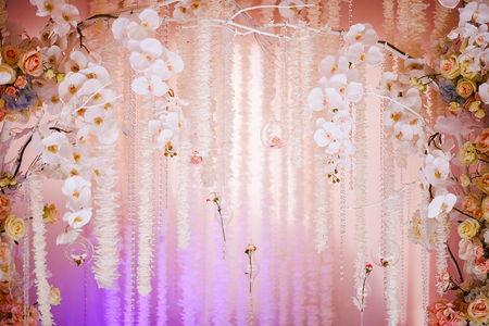 Wedding arch of fresh flowers. Delicate design of orchids and roses (close)の写真素材