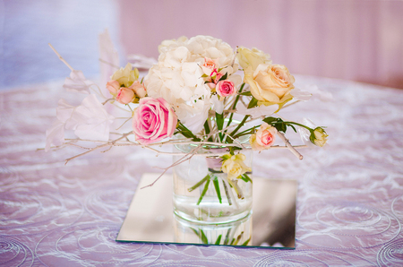 Decoration of fresh flowers on the table in a restaurantの写真素材