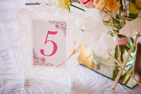 Wedding decoration. Room in a patterned frame on the table for guests. Closeの写真素材