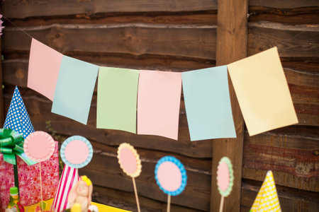 Multi-colored pieces of paper hanging on the rope as a children's holiday decorationsの写真素材