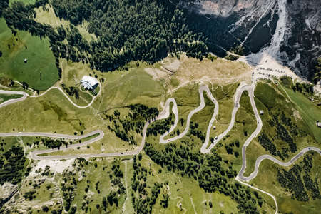 Serpentine in the Italian Alps. Gardena pass,Passo Gardena, Rifugio Frara, Dolomiti, Dolomites, South Tyrol, Italy Aerial amazing shot. view from aboveの写真素材