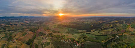 Beautiful Tuscany landscape in May on the sunset. Green panoramic perspective hills and fields....