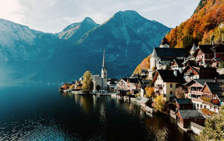 Scenic panoramic view of the famous mountain village in the Austrian Alps. Autumn Landscape. Hallstatt, Austria. Blue lake, sky and mountains. Beautiful and cozy town.Postcard concept.の写真素材