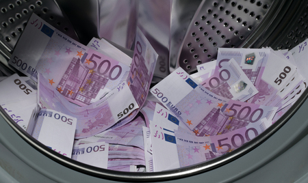 Financial crisis. Money laundering: money in the washing machine.の写真素材
