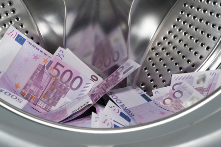 Financial crisis. Money laundering: money in the washing machine.の写真素材