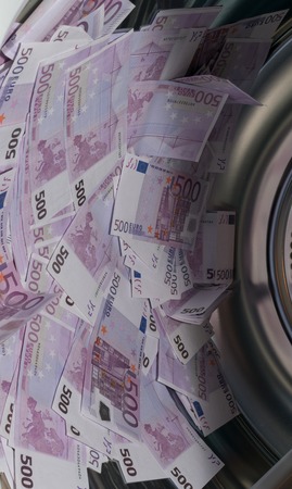 Financial crisis. Money laundering: money in the washing machine.の写真素材