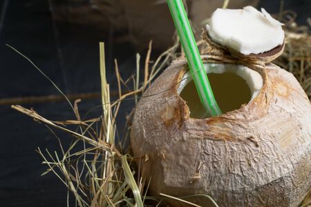 coconut with coco milk in the hay backgroundの写真素材