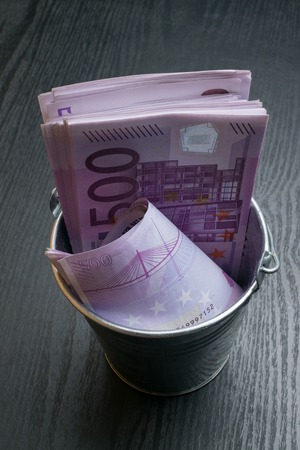 a full bucket of euro cash moneyの写真素材