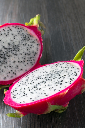 exotic organic fresh dragon fruit pitaya on the black tableの写真素材