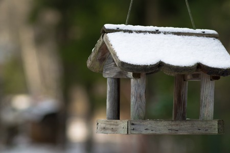 bird house in winter covered with snowの写真素材