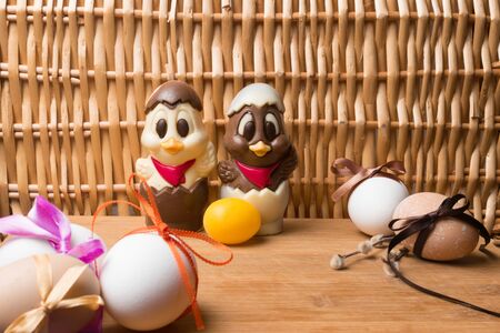 easter eggs with color ribbon and chocolate cute chicken on the orange background, april holidayの写真素材