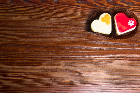 two fresh cakes, red and white, heart shapes on wooden background. Love delicious cakes.の写真素材