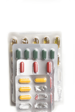 medicine color pills in packs.Pills in blister pack,Capsules and pill packed in blisters on the white backgroundの写真素材