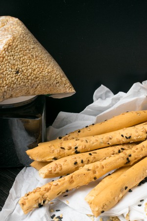 homemade snack, baked sticks with sesame and black cumin on the white napkins. Cristy sticks with seedsの写真素材