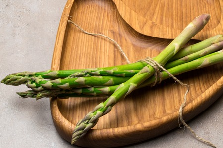 Raw organic asparagus on the wood board. Asparagus backgroundの写真素材