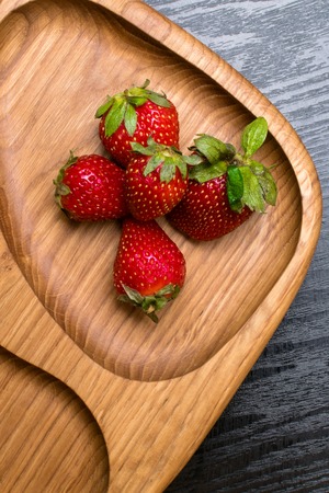 raw fresh strawberry in wooden background. Breakfast conception
