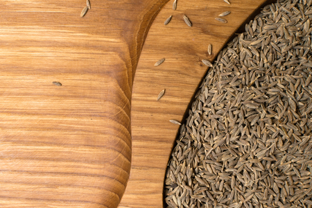 aromatic dried cumin in wooden background. Asian condimentの写真素材