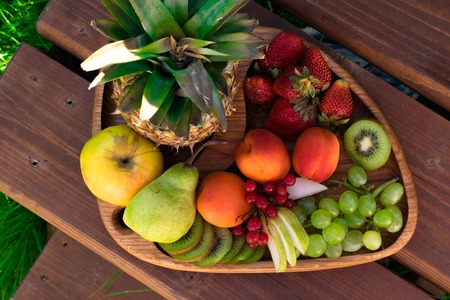 Mix of different exotic fresh colorful Fruits on dark wooden tableの写真素材