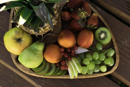 Mix of different exotic fresh colorful Fruits on dark wooden tableの写真素材