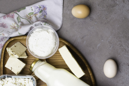 various dairy produkt on grey table with flower towel and wood board. Calcium sourceの写真素材