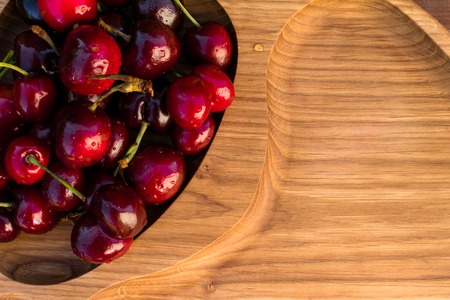 Fresh cherries in the wooden board, fruits on wood table. Healthy vitamin sourceの写真素材