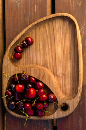 Fresh cherries in the wooden board, fruits on wood table. Healthy vitamin sourceの写真素材