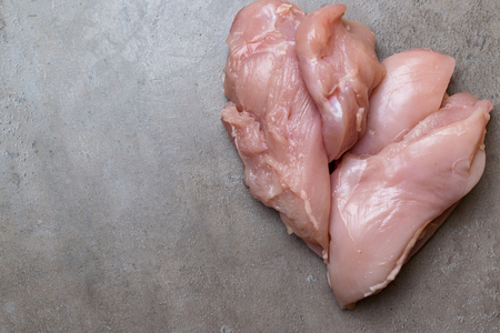 raw fresh chicken or turkey fillet isolated on grey background. Diet meatの写真素材