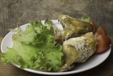 Grilled chicken with mayonnaise, with vegetables, lettuce, tomatoes, bulgur on a white plate. Low-calorie, dietary food for a healthy lifestyle. Wooden table, burlapの写真素材